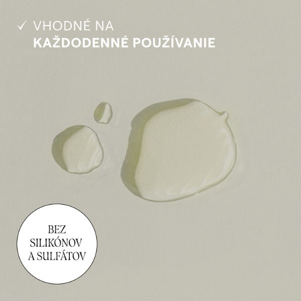 WELEDA Rozmarínové vlasové tonikum proti vypadávaniu vlasov na každodenné používanie Tri kvapky tekutiny na svetelnom povrchu, slovenský text s informáciou, že WELEDA Rozmarínové vlasové tonikum proti vypadávaniu je bez silikónov a sulfátov